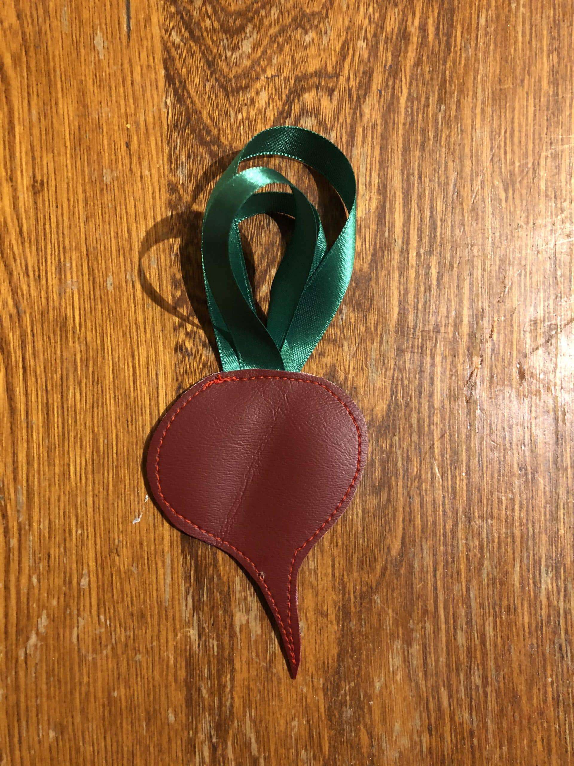 Upcycled ornament, freehand stitched exclusively from costume shop scraps. Beetroot Ornament