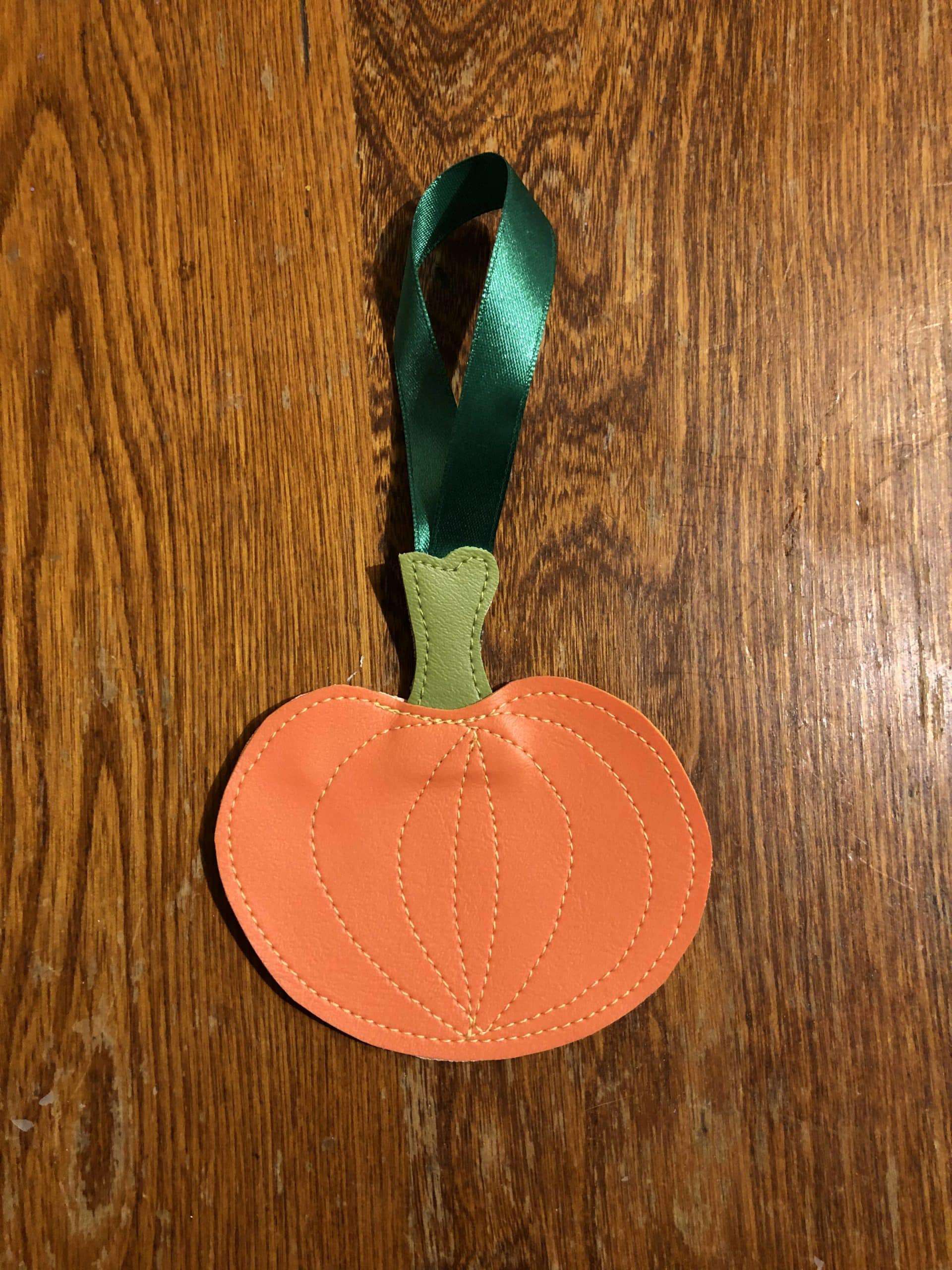 Upcycled ornament, freehand stitched exclusively from costume shop scraps. Pumpkin Ornament
