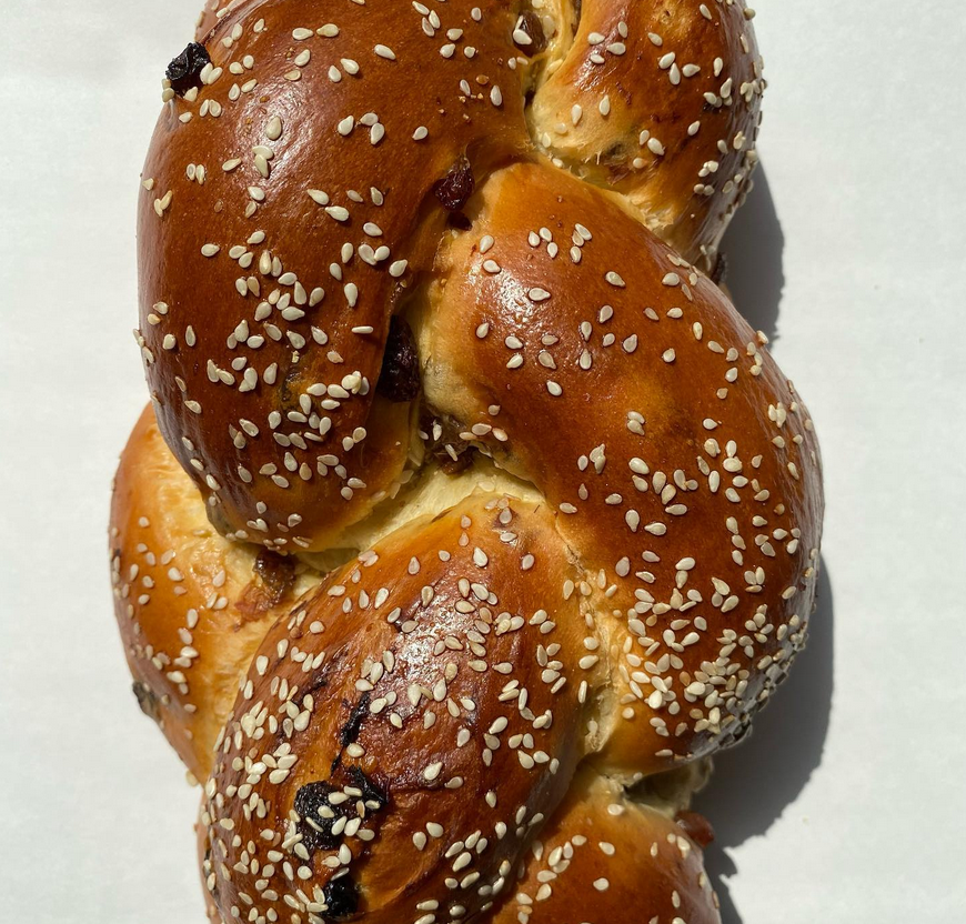 Our traditional challah dough filled and braided with loads of raisins. Ingredients: Transitional Wheat Flour, Eggs, Water, Raisins, Organic Cane Sugar, Sunflower Oil, Fresh Yeast, Sea Salt, Organic Cornmeal
*Available with or without Sesame Seeds
ALLERGENS: GLUTEN, EGGS, SESAME SEEDS raisin challah Our traditional challah dough filled and braided with loads of raisins. Ingredients: Transitional Wheat Flour, Eggs, Water, Raisins, Organic Cane Sugar, Sunflower Oil, Fresh Yeast, Sea Salt, Organic Cornmeal
*Available with or without Sesame Seeds
ALLERGENS: GLUTEN, EGGS, SESAME SEEDS
