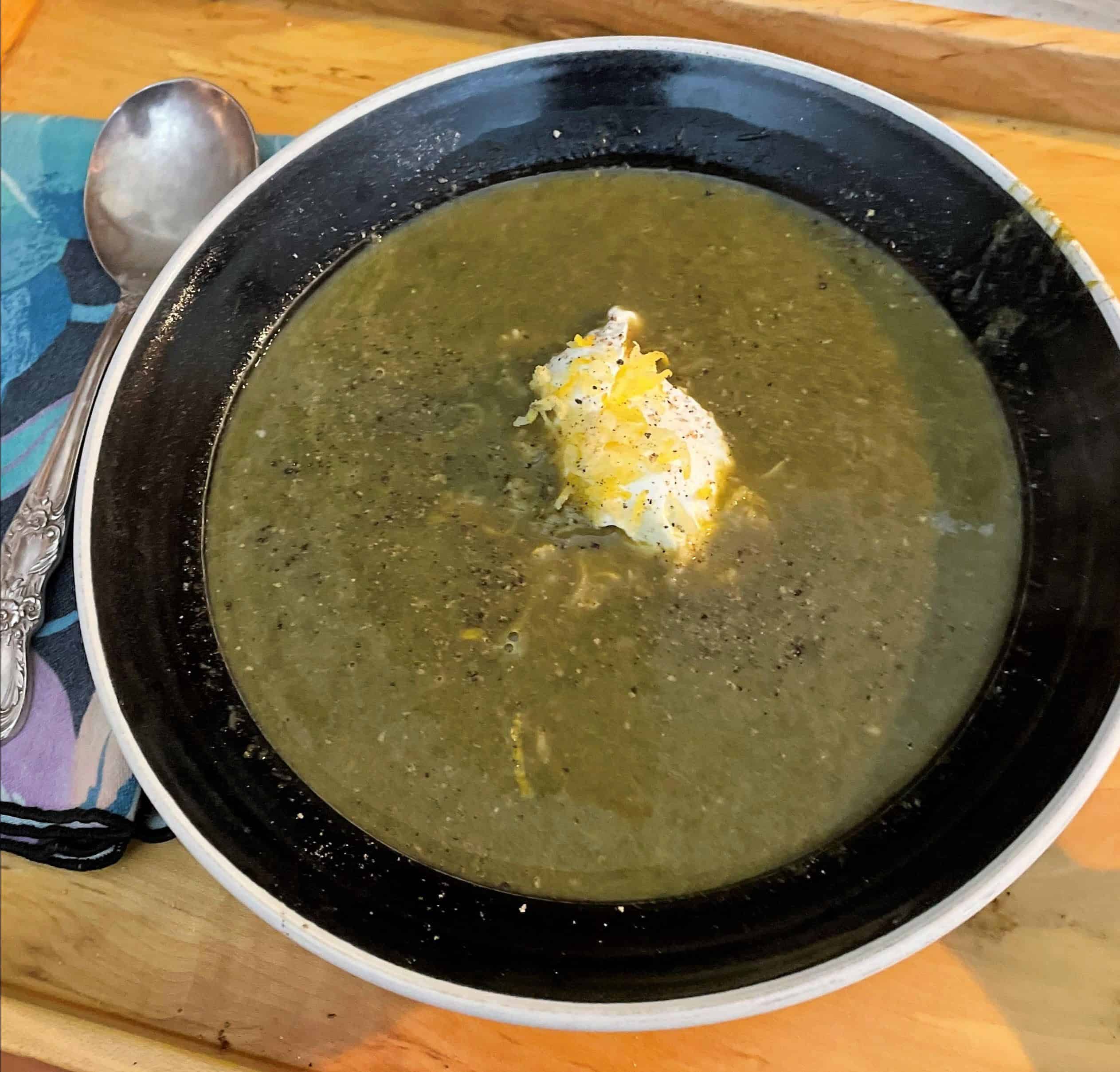 Dark green soup in wide bowl