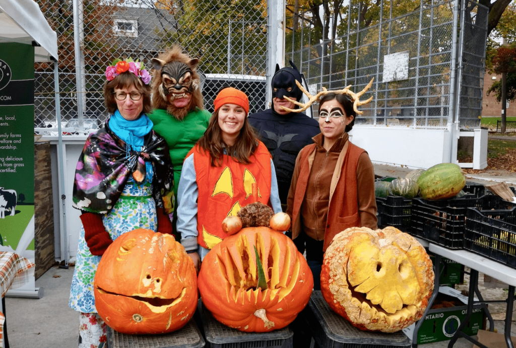 in person market halloween in costumes scary pumpkins