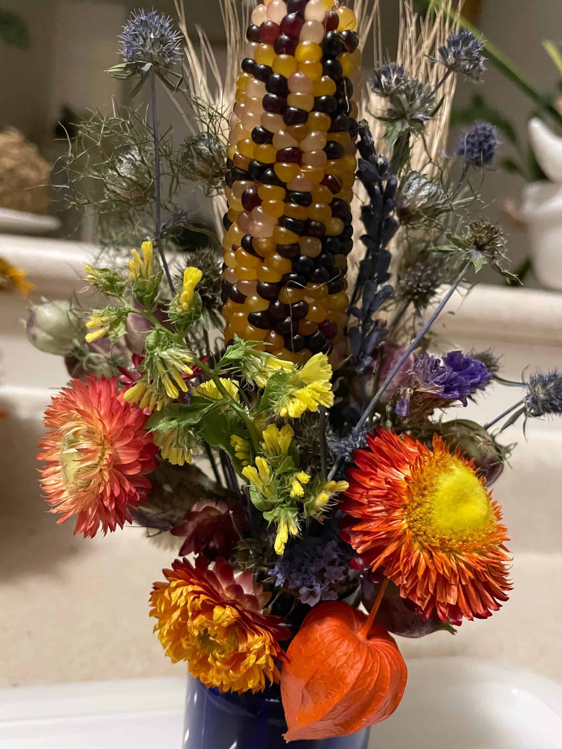 a dryied mini arrangement in an attractive cobalt blue plastic bottle Mini dryed floral arrangement