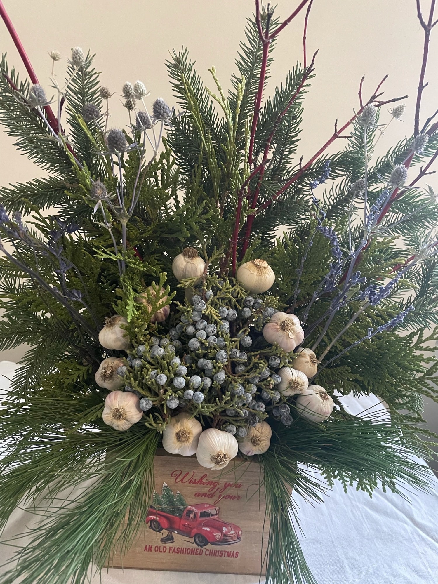 A nice mix of our music garlic and farm evergreen w dry flowers, a conversation piece Garlic Pine Centrepiece A nice mix of our music garlic and farm evergreen w dry flowers, a conversation piece