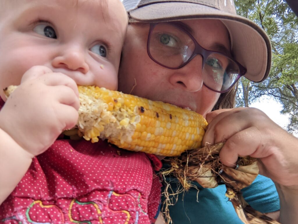 Kid and parent eating corn on the cob 1